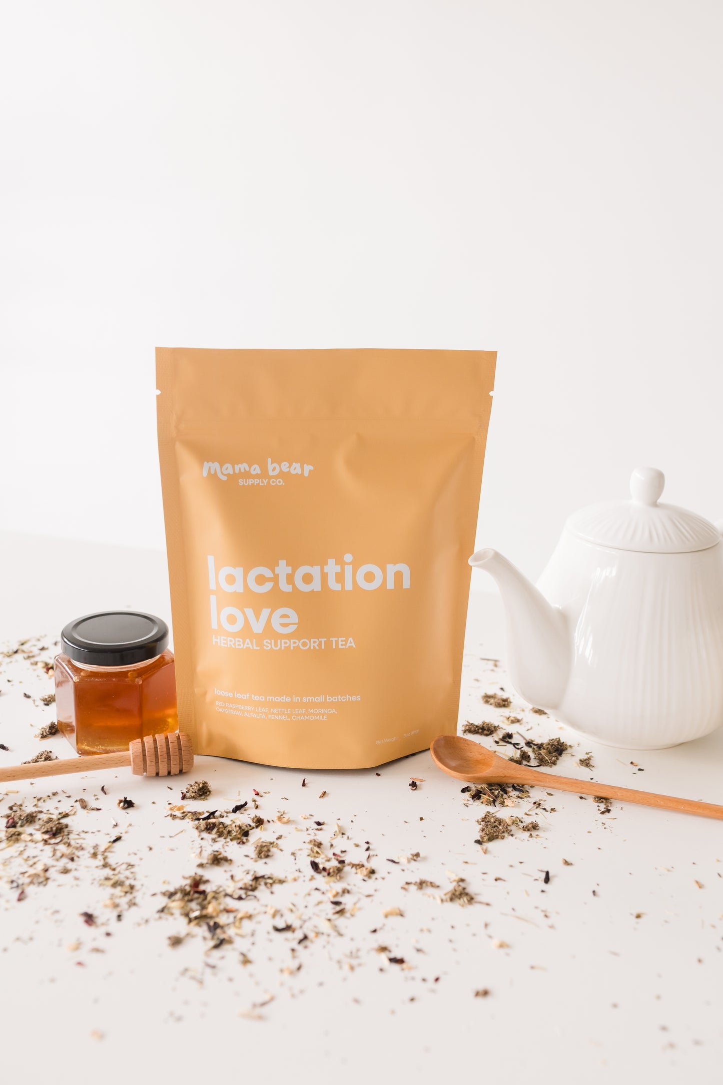 Tea package labeled 'Lactation Love' with a teapot and honey on a white background