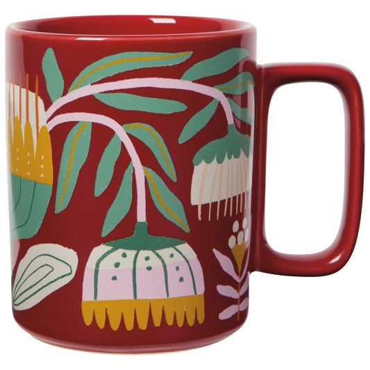 Red mug with floral pattern on a white background